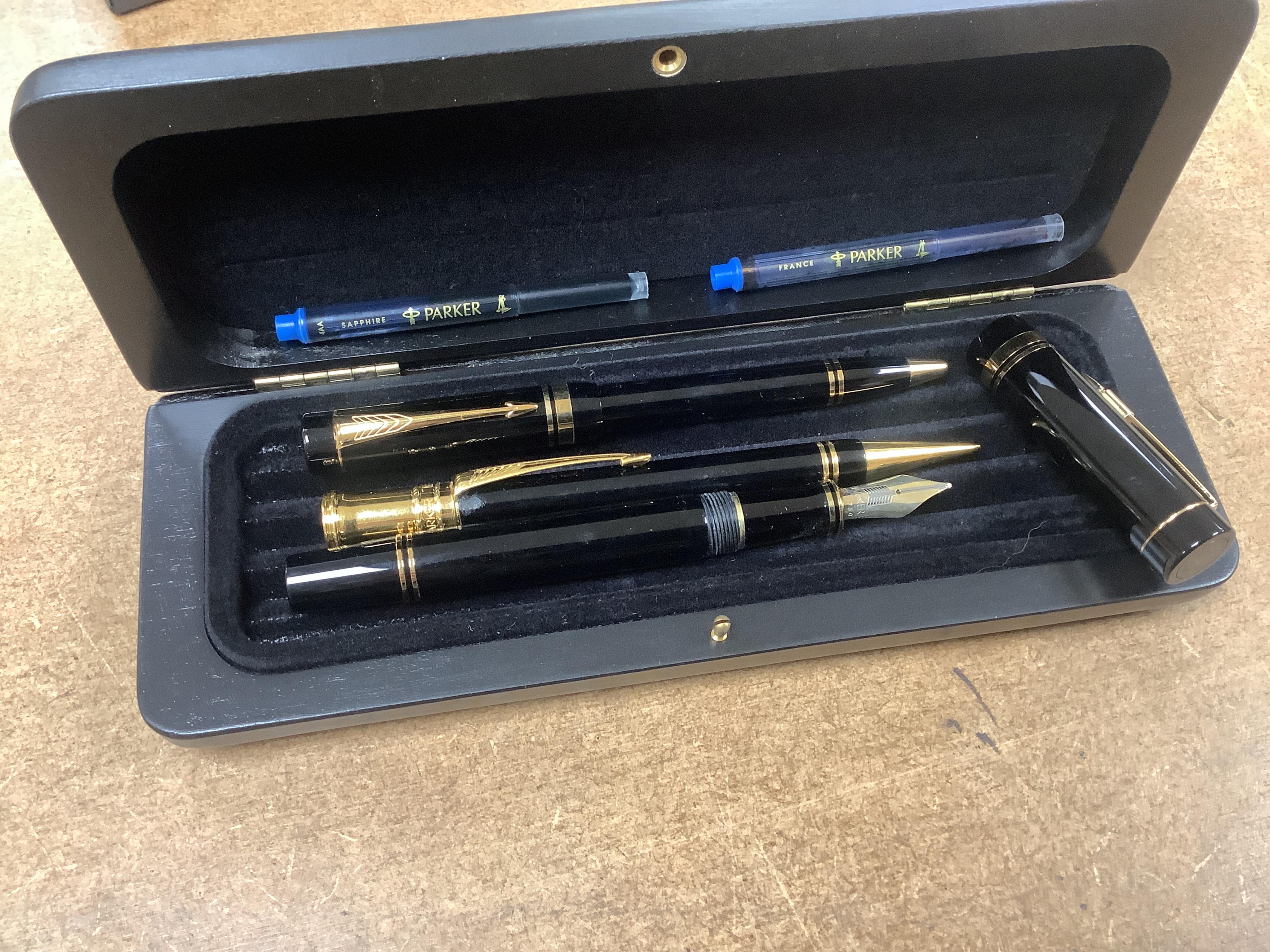 A quantity of various pens to include Parker Duofold and two Parker pen cases. Condition - varies